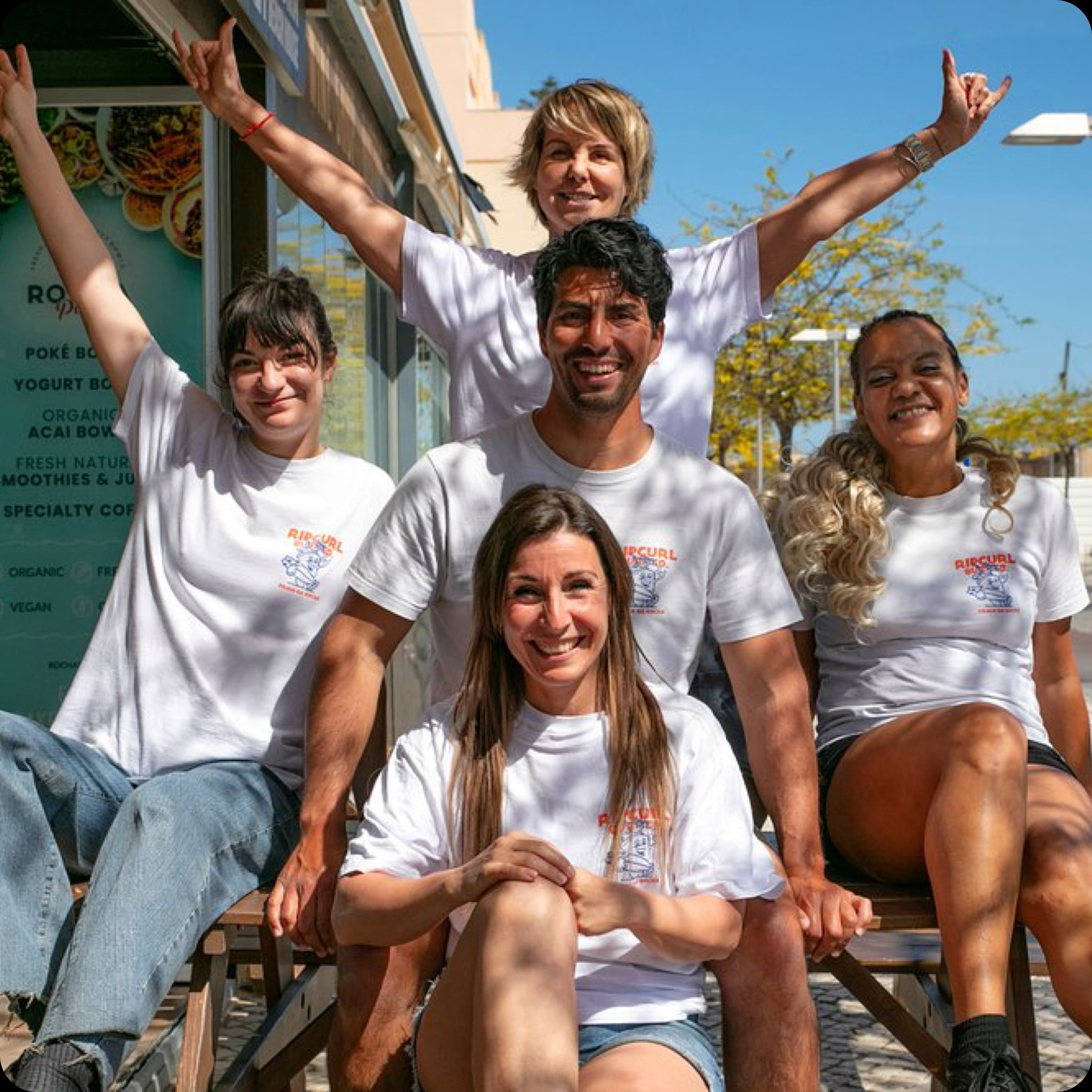 A happy group of friends posing together and smiling, representing the Rocha Beach House community.