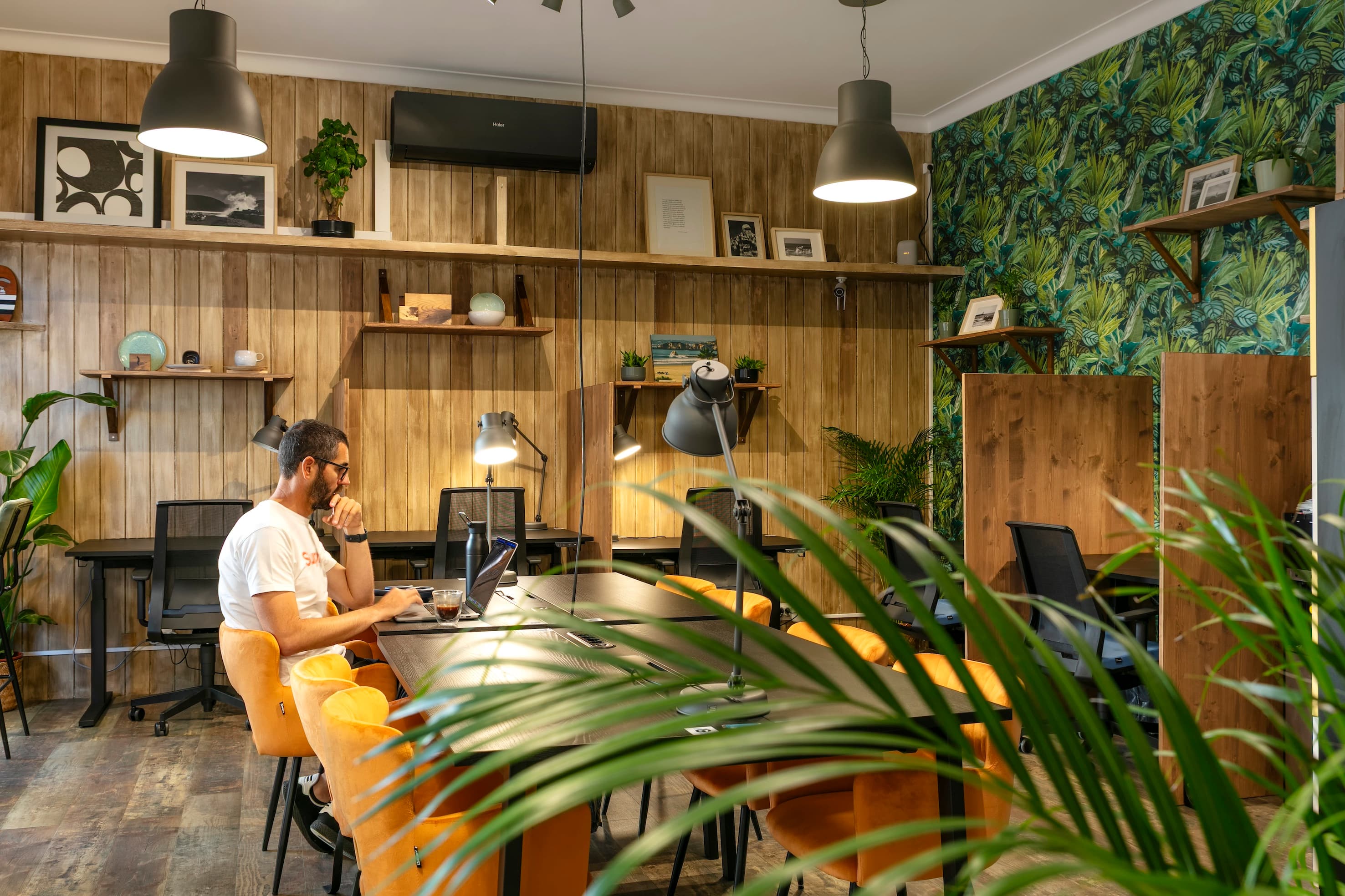 Modern coworking space with bright orange chairs.